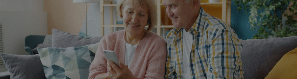 Para seniorów korzystająca z aplikacji mobilnej stworzonej dla branży opiekuńczej i healthcare.